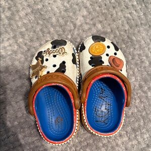 CROCS Kids' Cow Print Slippers with Brown and Blue Accents